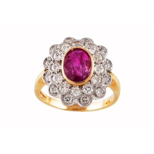 A RUBY AND DIAMOND CLUSTER RING, the oval ruby to a two rowe...