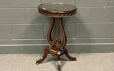 A Regency style mahogany and brass applied circular occasional table, with lyre support raised on