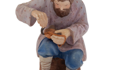 A Russian Porcelain Figure of a Bast Shoe Maker
