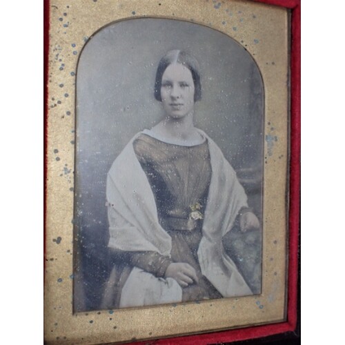 A TINTED DAGUERREOTYPE PHOTOGRAPH, OF A GIRL mid 19th cent...