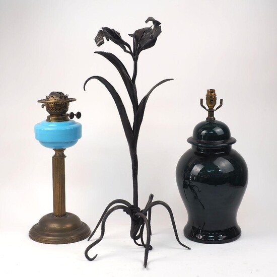 A brass and blue glass oil lamp, early 20th century, 44cm high, together with a modern green glazed table lamp, 44cm high, and an iron pricket candlestick cast as a flower, 64.5cm high (3)