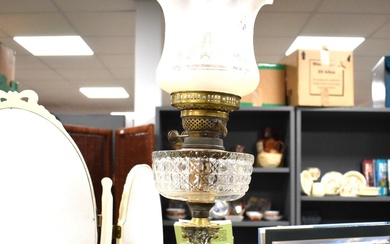 A brass oil lamp with corinthiun column base with cut glass reservoir and fluted etched shade and