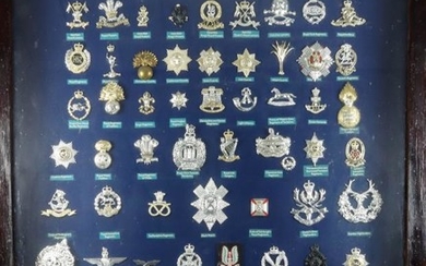 A collection of British Military cap badges, mounted in...