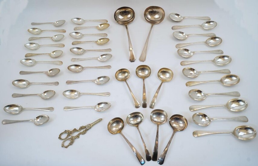 A collection of silver plate, comprising: twelve dessert spoons; twelve soup spoons and nine dessert spoons by Rogers; fifteen table forks and twenty-two dessert forks by Rogers; a pair of grape scissors; two Art Deco style forks; a large Mappin &...