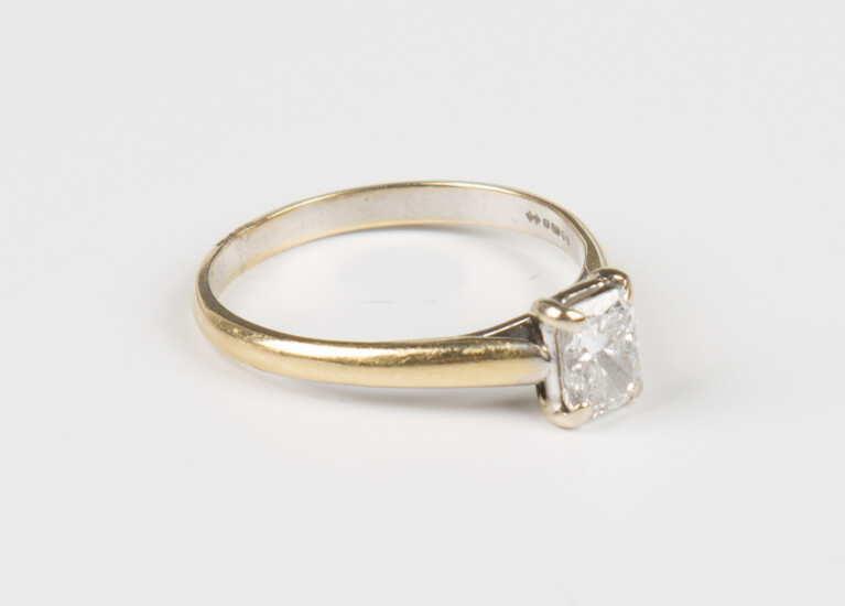 A gold and diamond single stone ring, claw set with a rectangular cut diamond, detailed '18K