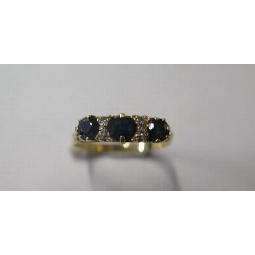 A gold sapphire and diamond seven stone carved hoop ring, wi...