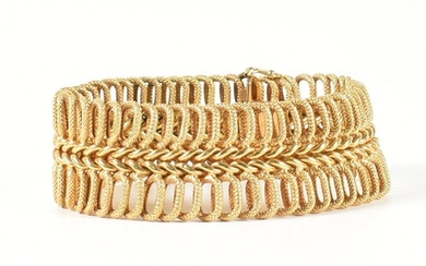 A hallmarked Italian 18ct gold woven link bracelet. The 18ct...