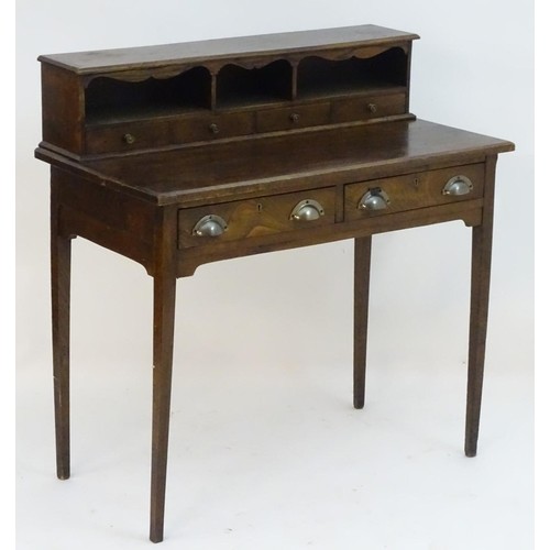 A late 19thC oak writing desk with a moulded top section abo...