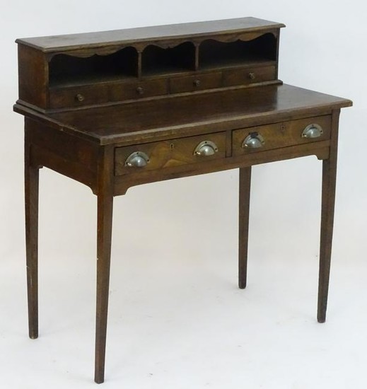 A late 19thC oak writing desk with a moulded top