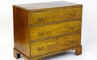 A late Georgian mahogany chest of drawers with a rectangular moulded top above three long drawers