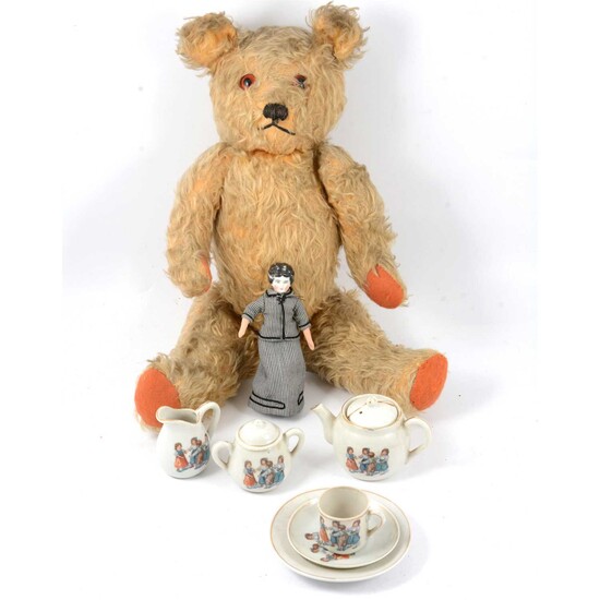 A mid-20th century mohair teddy bear, miniature doll and tea set.