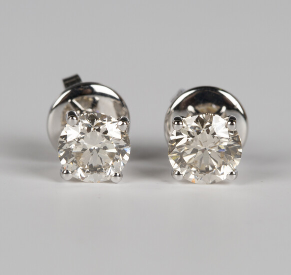 A pair of 18ct white gold and diamond single stone earrings, each claw set with a circular cut diamo