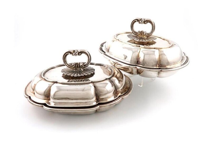 A pair of early-Victorian silver entrée dishes and covers, by Benjamin Smith, London 1843, shaped oval form, moulded borders, the pull-off covers with matched detachable fluted scroll handles, length 29.8cm, approx. weight 100oz. (2) Provenance:...