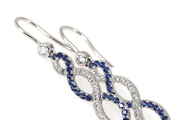 A pair of sapphire and diamond ear pendants each set with numerous...