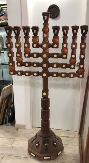 A very large antique menorah made of crumbling wood