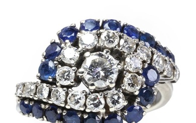 A white gold sapphire and diamond crossover ring