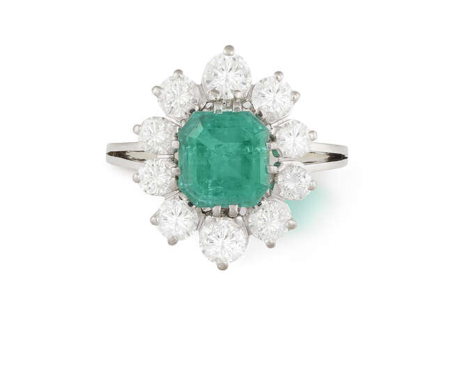 AN EMERALD AND DIAMOND CLUSTER RING Composed of...