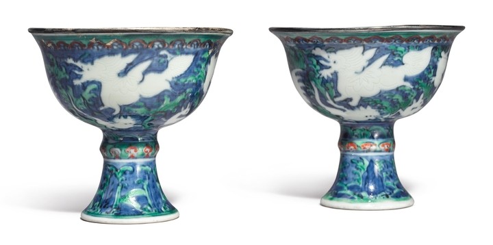AN EXTREMELY RARE PAIR OF BLUE-GROUND IRON-RED AND GREEN-ENAMELED 'MYTHICAL BEASTS' STEM CUPS WANLI MARKS AND PERIOD
