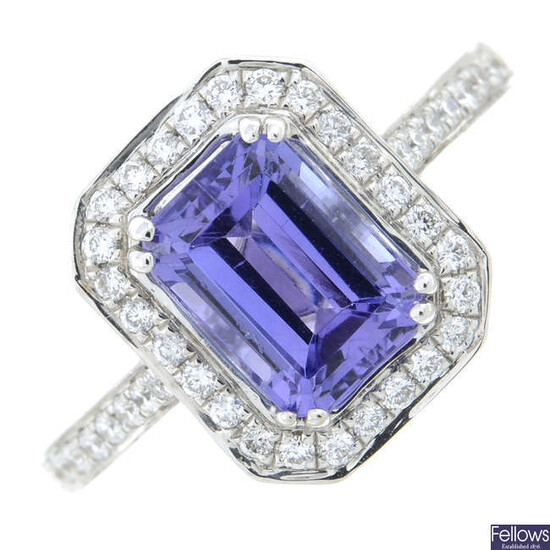 An 18ct gold tanzanite and diamond cluster ring, with diamond line shoulders.