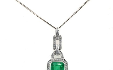 An 18ct white gold Colombian emerald and diamond pendant and chain