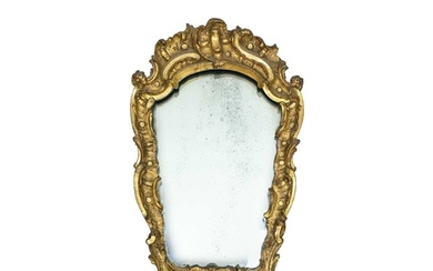 An 18th century baroque wood carved gesso gilt mirror. 77cm ...