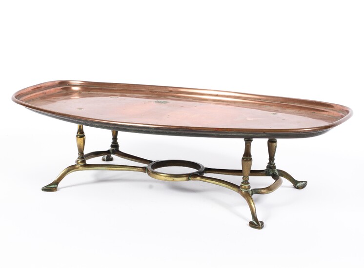 An Arts and Crafts WAS Benson copper and brass footed warming tray, of shaped oval form