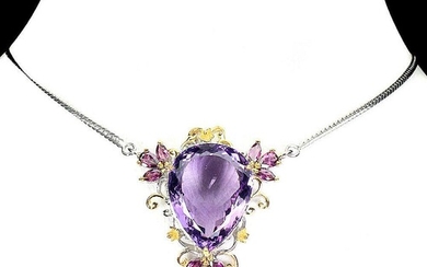 SOLD. An amethyst necklace set with an oval-cut amethyst and numerous circular-cut rhodolite garnets, mounted in rhodium and gold plated sterling silver. L. 50 cm. – Bruun Rasmussen Auctioneers of Fine Art