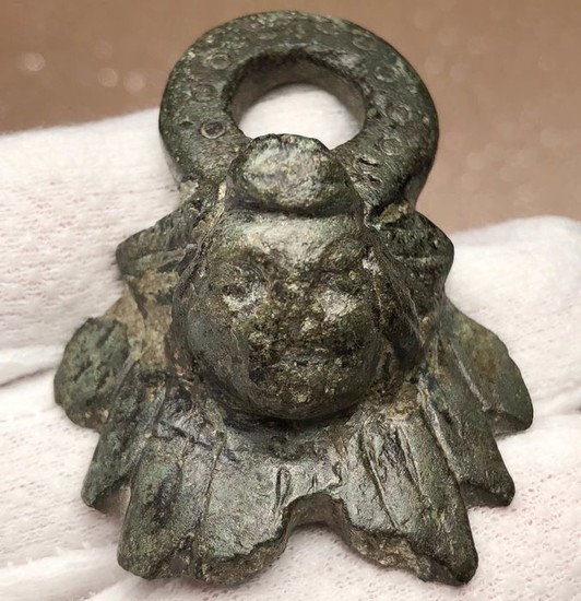 Ancient Roman Bronze Unusually Big Pendant Applique with an embossed head of an Eros.
