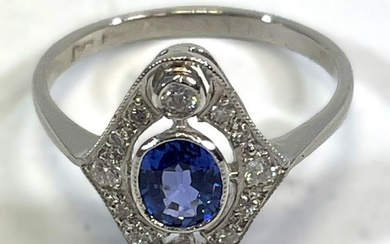 Art Deco-style platinum diamond and sapphire ring. Set with an...