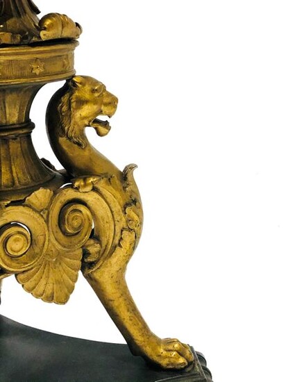 Console table in gilded metal, the was decorated with lions leaning against each other forming a tripod base with claw foot. They rest on a triangular base with scrolls and support an enamelled ceramic tray.
