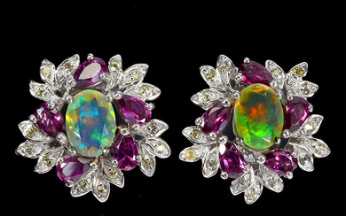 Earrings in rhodium-plated Sterling silver with opals and sapphires.