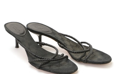 SOLD. Gucci: A pair of sandals with black braided straps made of leather, black monogram...