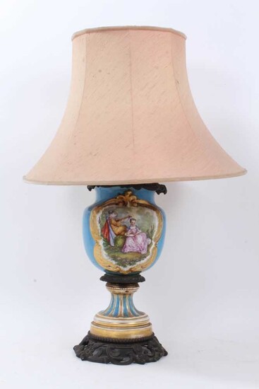 Late 19th century French porcelain and bronze mounted oil lamp converted to electric lamp with painted romantic scene and floral reserve - with shade.