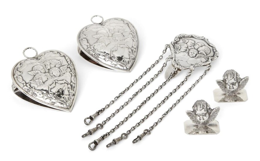 Lots 85-109: Property from a private collection. Two heart-shaped Edwardian silver paperclips, London, 1903 & 1904, William Comyns, together with a silver chatelaine clip, Birmingham, 1900, Levi & Salaman, and two small putto head ornaments, total...