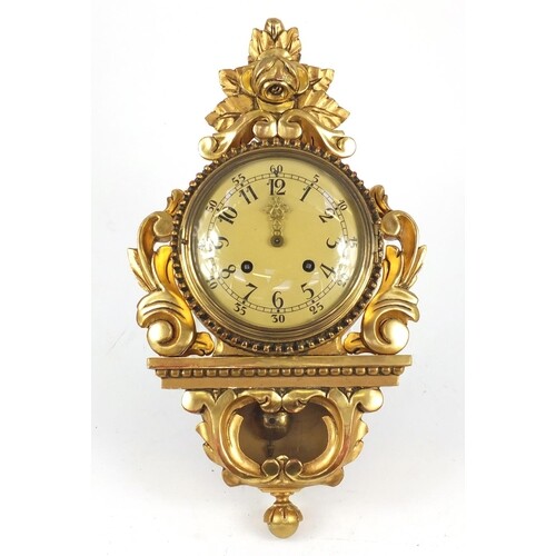 Ornate gilt wood cartel type clock with Arabic numerals, 49c...