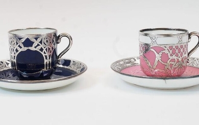 Two Minton Secessionist coffee cups and saucers, late 19th / early 20th century, comprising: a blue ground example with white metal pierced and scrolling foliate mounts, with printed green marks to underside, cup 5.8cm high, saucer 12.5cm diameter;...