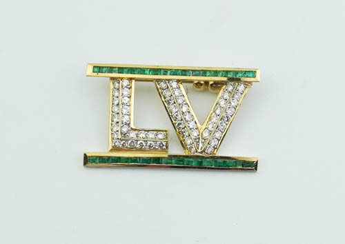 UNMARKED YELLOW GOLD, DIAMOND AND EMERALD "LV" MONOGRAM PIN. Two...