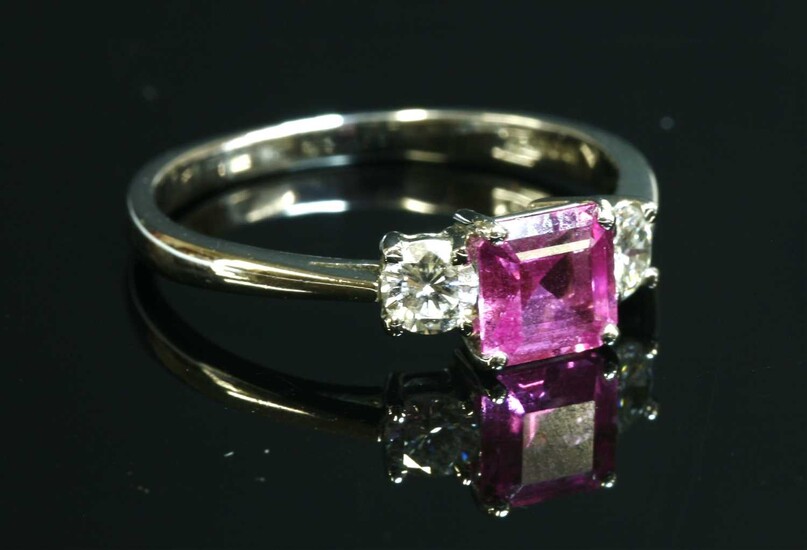 An 18ct white gold three stone pink sapphire and diamond ring