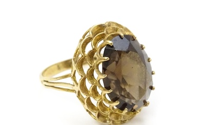 A 9ct gold ring set with central smoky quartz. Ring size app...