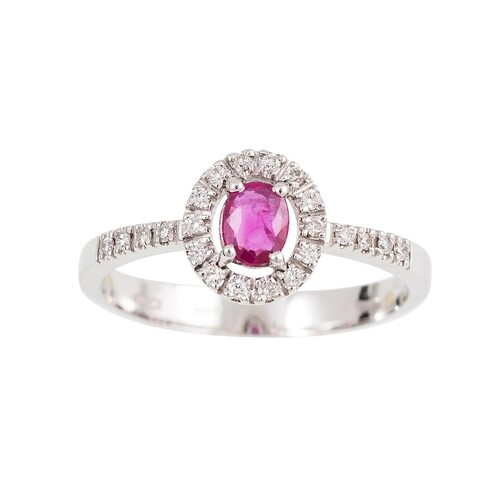A DIAMOND AND RUBY CLUSTER RING, the oval ruby to a brillian...