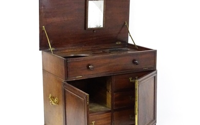 A Georgian mahogany campaign washstand with a mirror to the ...