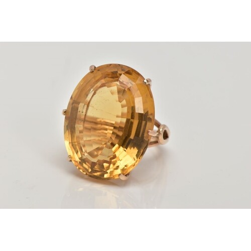 A LARGE CITRINE DRESS RING, yellow metal ring, six claw set,...