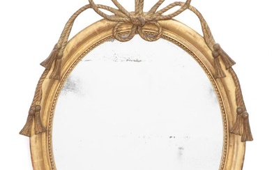 A Louis XVI style oval giltwood mirror decorated with bow and ribbons....