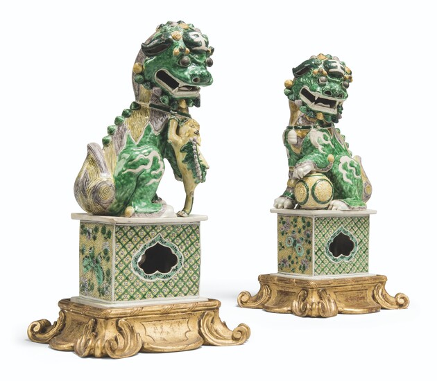 A PAIR OF CHINESE FAMILLE VERTE BISCUIT BUDDHIST LIONS