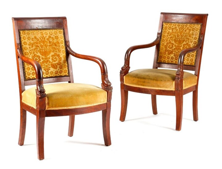 A PAIR OF FRENCH RESTORATION MAHOGANY FAUTEUILS EARLY 19TH CENTURY each with a damask padded back with carved dolphin arms, above anthemion tablets, on sabre front legs (2)