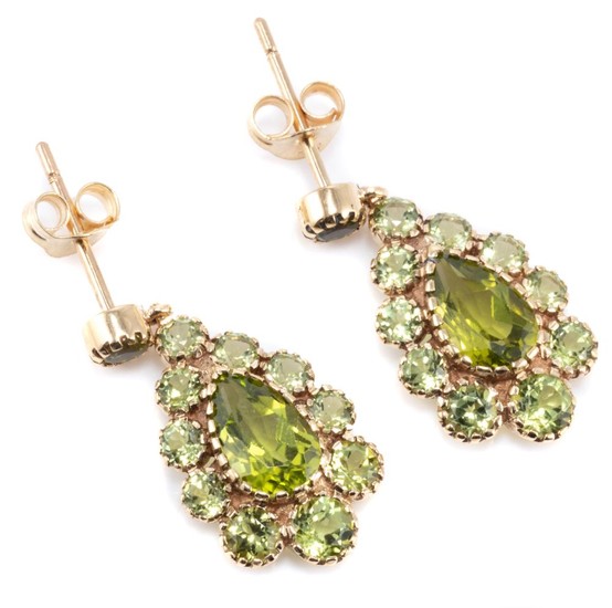 A PAIR OF VICTORIAN STYLE PERIDOT CLUSTER EARRINGS; drop shape clusters each centring a pear cut peridot to surround and stud fittin...
