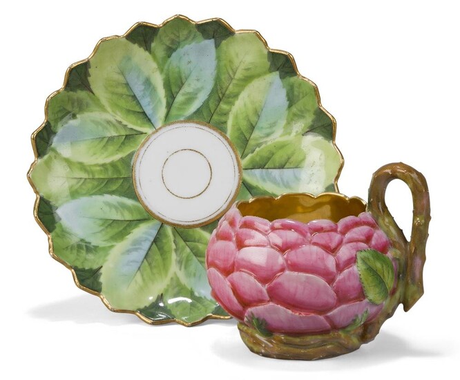 A Paris porcelain (Darte) cup and a saucer, c.1820, gilt Darte Freres a Paris mark to cup, saucer with removed mark and green 61. mark, the cup formed as a pink rose, the stem handle with leaf terminals and issuing from a meandering stem wrapped...