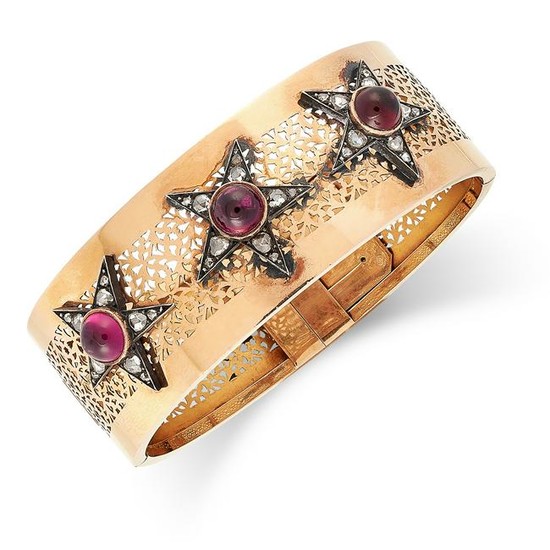 A RUBY AND DIAMOND BANGLE set with cabochon garnets and