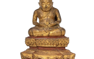 A Thai 19th century gilt and painted bronze Sankachai Buddha seated on...