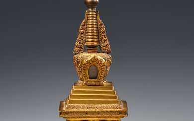 A Tibetan fire-gilt bronze bumpa-stupa. 18th century or later